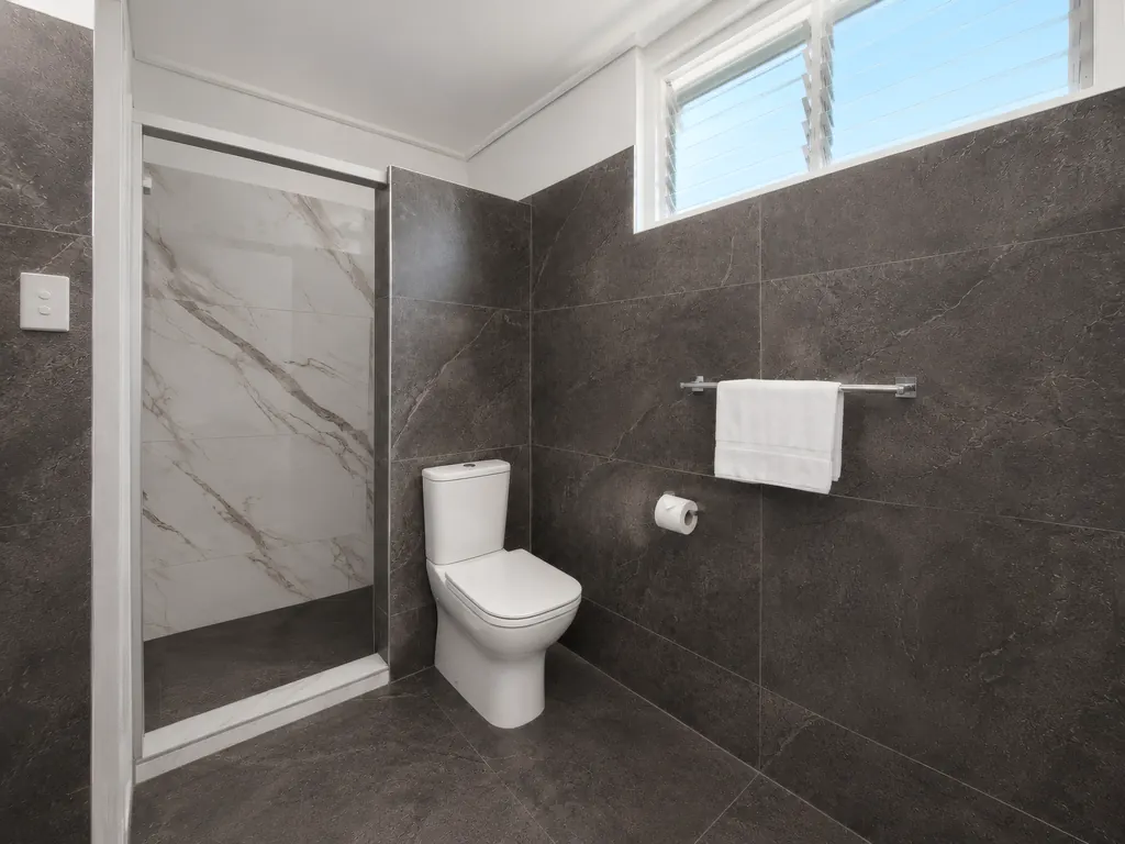 Private bathroom with a marble-tiled walk-in shower