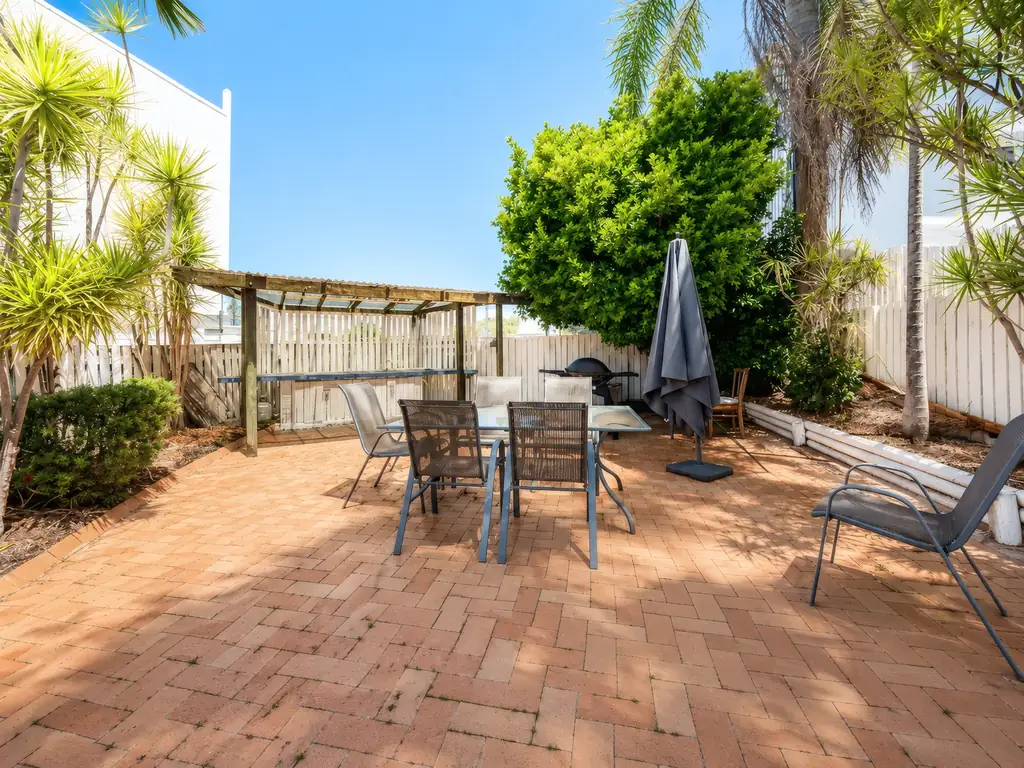 Private courtyard with outdoor dining table and BBQ
